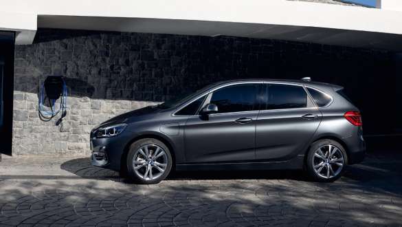 BMW 225xe Active Tourer híbrido plug-in, F45, perspetiva lateral BMW 225xe Active Tourer híbrido Plug-in, F45, perspetiva lateral a três quartos, em frente a um edifício