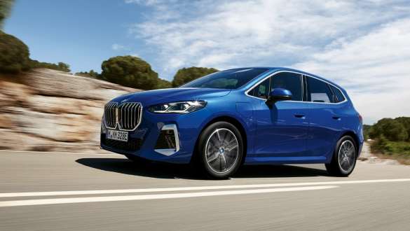 BMW Série 2 Active Tourer 230e híbrido plug-in, U06, 2021, em movimento numa estrada secundária BMW Série 2 Active Tourer 230e híbrido plug-in, U06, 2021, pintura azul Portimao M metalizada, perspetiva lateral a três quartos, em movimento numa estrada secundária