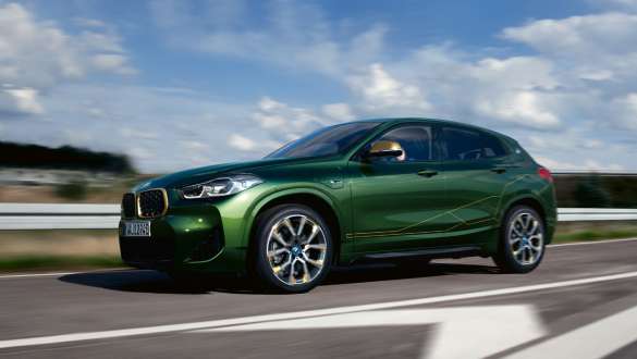 BMW X2 xDrive25e híbrido plug-in, F39, perspetiva lateral a três quartos, em movimento BMW X2 xDrive25e híbrido plug-in, F39, perspetiva lateral a três quartos, em movimento na rua