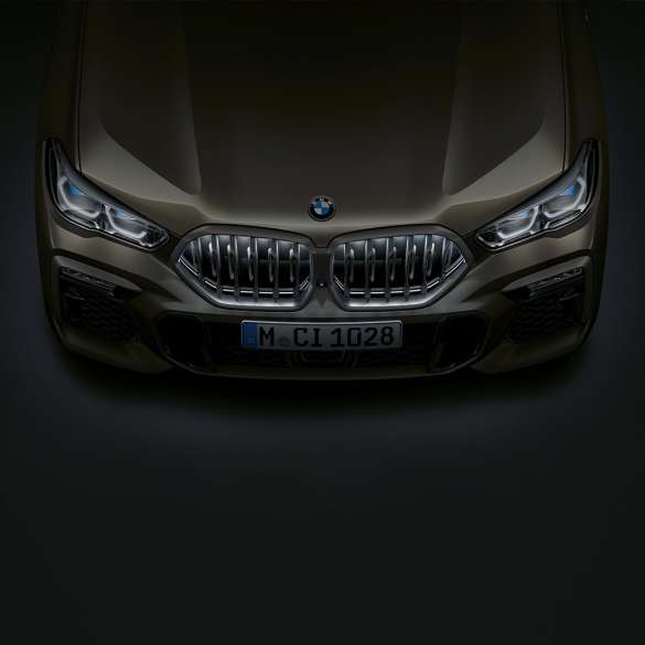 Dianteira do BMW X6. Grande plano da dianteira do BMW X6 com a grelha BMW em forma de rim "Iconic Glow" numa perspetiva de topo.