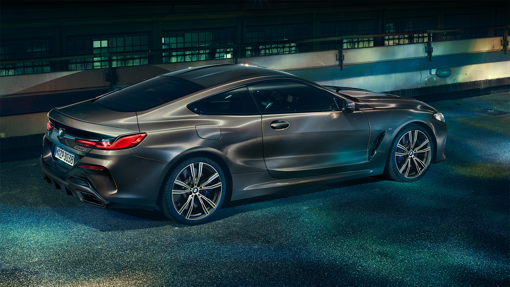 Still shot of the BMW 8 Series Coupé with BMW Individual equipment from the side in an urban setting at night. Still shot of the BMW 8 Series Coupé with BMW Individual equipment from the side in an urban setting at night.
