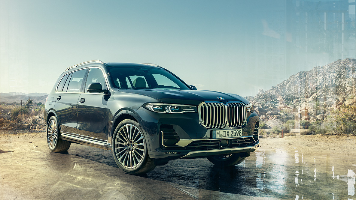 Exterior do BMW X7, perspetiva frontal a três quartos Exterior do BMW X7: perspetiva frontal a três quartos em frente a uma paisagem de deserto