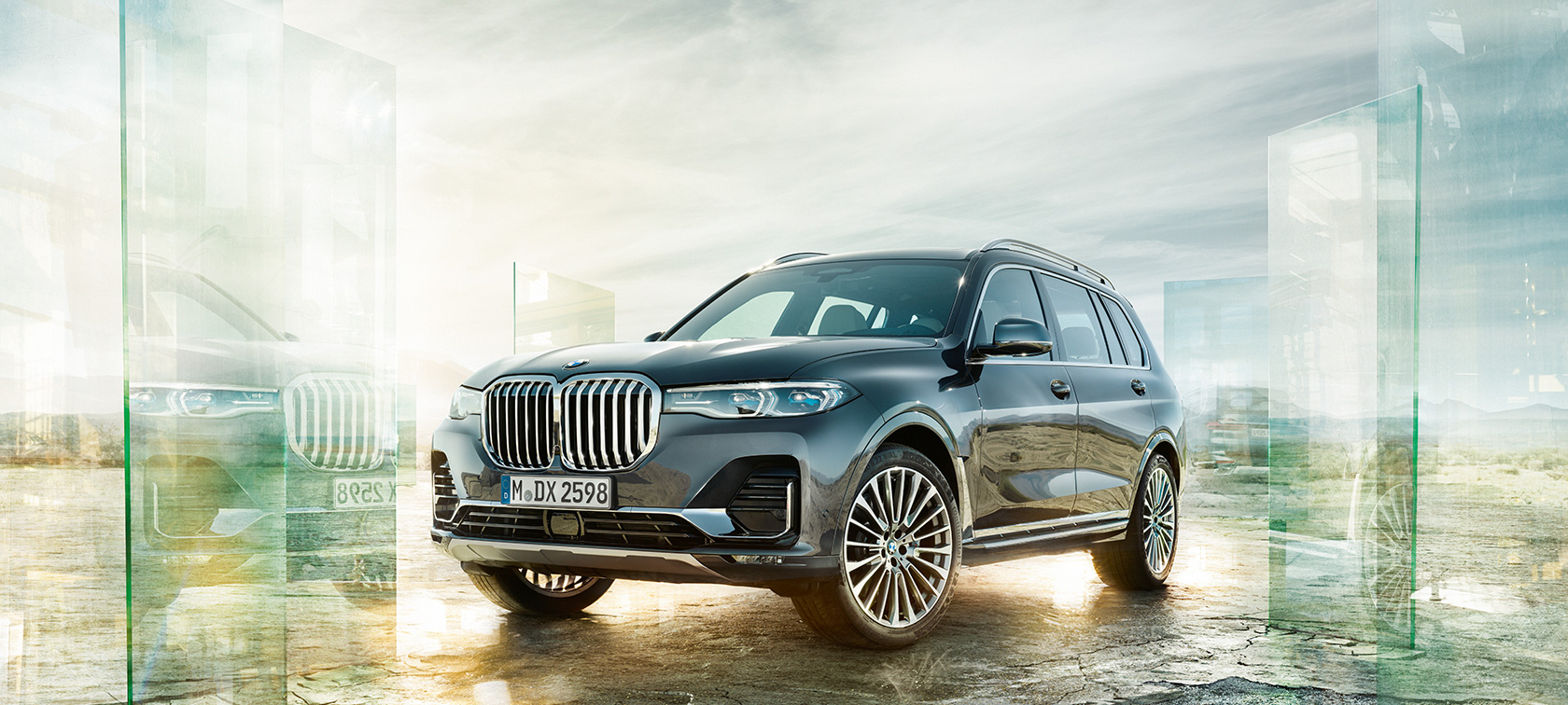 BMW X7, perspetiva frontal a três quartos Perspetiva frontal a três quartos do BMW X7 em frente a uma paisagem de deserto