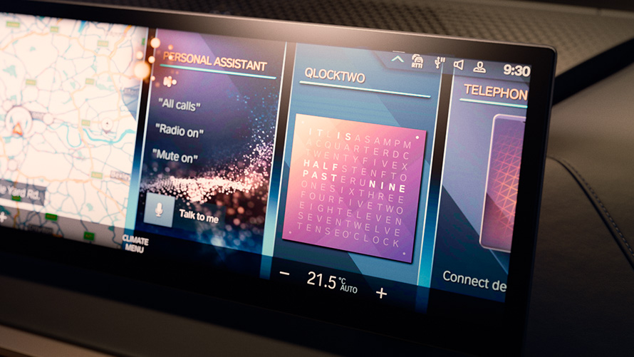 BMW iX (i20), grande plano, visor de informações central, vista do QLOCKTWO® Atualização de software à distância, BMW iX (i20), grande plano, visor de informações central, vista do QLOCKTWO®